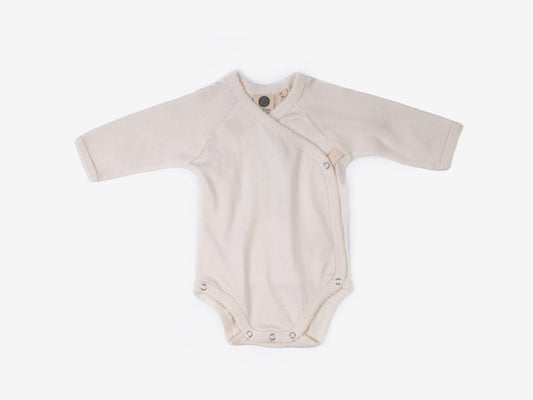 Baby crossover bodysuit in alabaster organic Egyptian cotton, front view