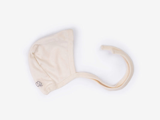 Newborn crossover bodysuit in alabaster organic Egyptian cotton, front view