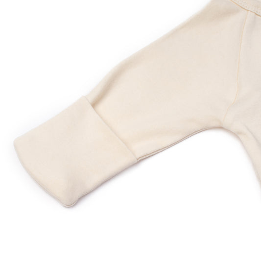 Newborn crossover bodysuit in alabaster organic Egyptian cotton, lifestyle view