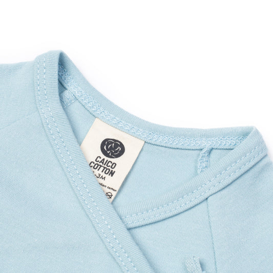 Newborn crossover bodysuit in dusky blue organic Egyptian cotton, detail view
