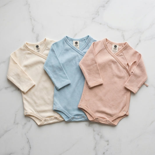 Crossover Bodysuit 3-Pack — Alabaster, Dusky Blue, Dusty Blush on marble